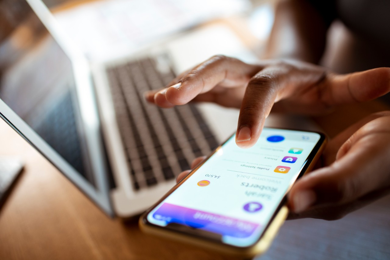 Close up of a mid adult woman using a banking app on her phone
